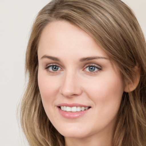 Joyful white young-adult female with long  brown hair and green eyes