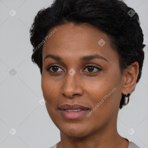 Joyful black young-adult female with short  black hair and brown eyes