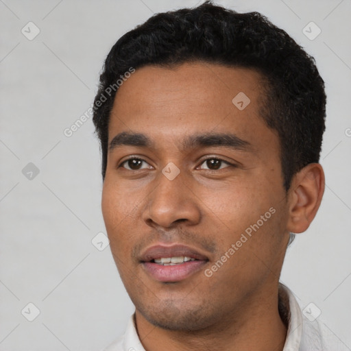 Joyful latino young-adult male with short  black hair and brown eyes