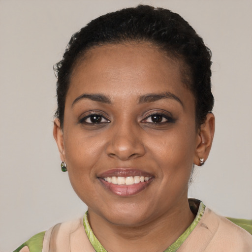 Joyful black young-adult female with short  brown hair and brown eyes