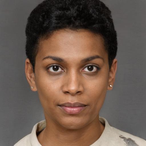 Joyful black young-adult female with short  black hair and brown eyes