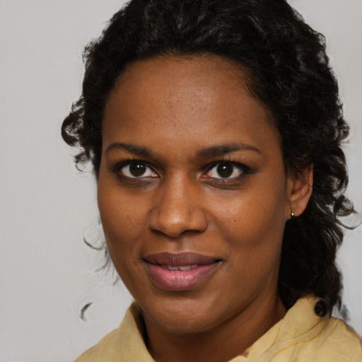 Joyful black young-adult female with medium  brown hair and brown eyes