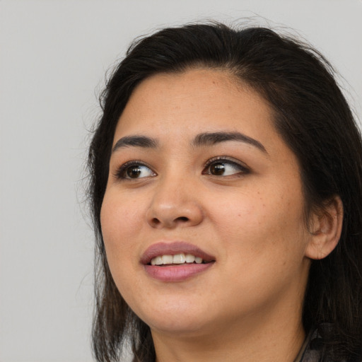 Joyful asian young-adult female with long  brown hair and brown eyes
