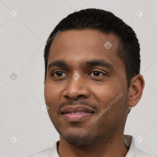 Joyful black young-adult male with short  black hair and brown eyes