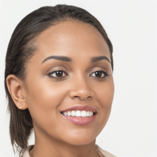 Joyful latino young-adult female with medium  brown hair and brown eyes