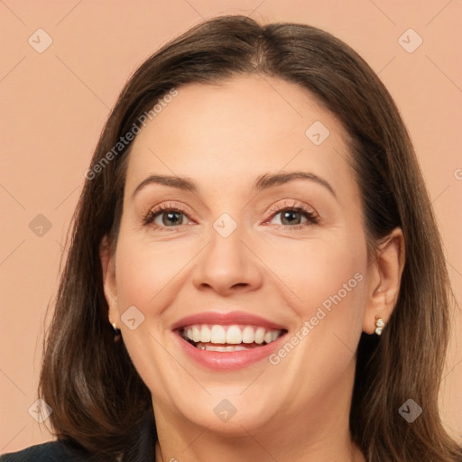 Joyful white adult female with long  brown hair and brown eyes