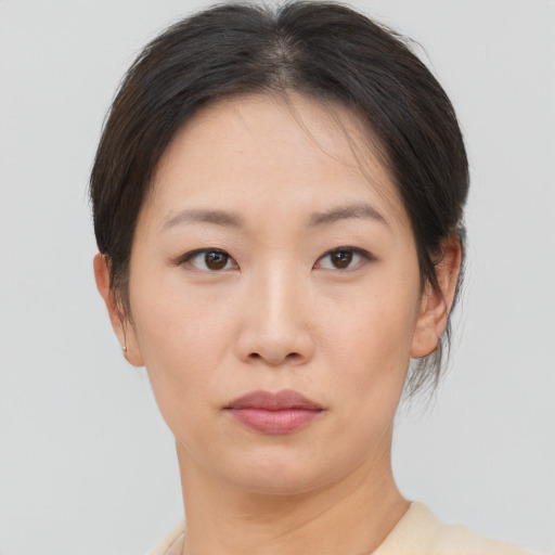Neutral asian young-adult female with short  brown hair and brown eyes
