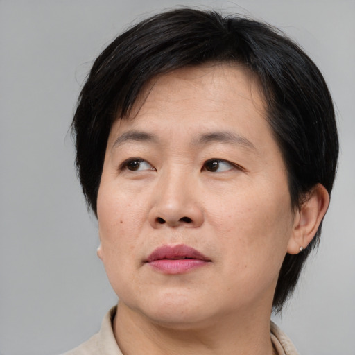 Joyful asian adult male with medium  brown hair and brown eyes