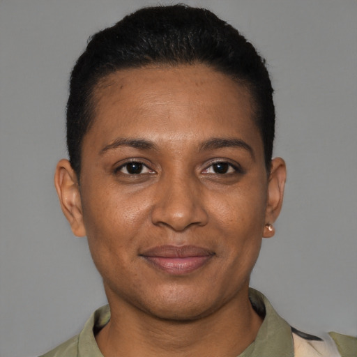 Joyful black young-adult female with short  black hair and brown eyes