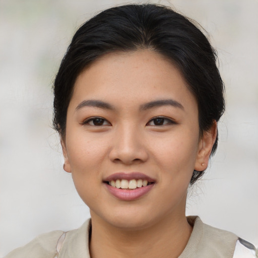 Joyful asian young-adult female with medium  brown hair and brown eyes