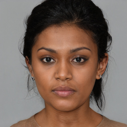 Neutral black young-adult female with medium  brown hair and brown eyes
