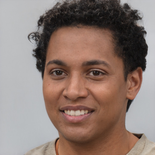 Joyful black young-adult female with short  brown hair and brown eyes