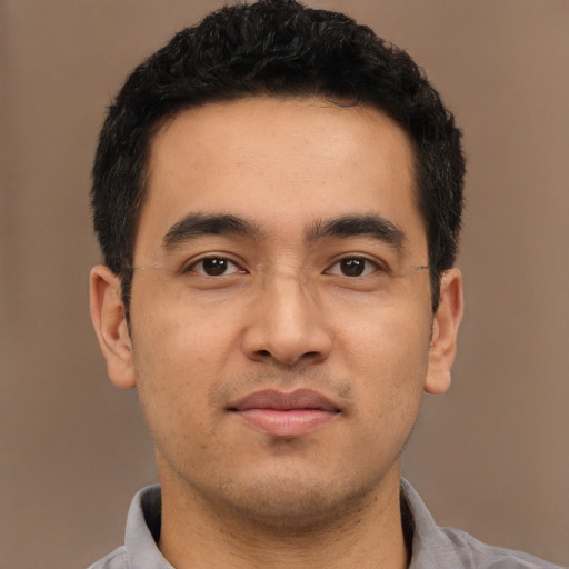 Joyful latino young-adult male with short  black hair and brown eyes