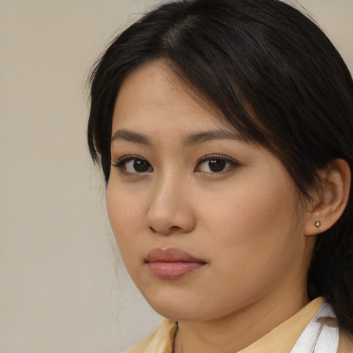 Neutral asian young-adult female with medium  brown hair and brown eyes