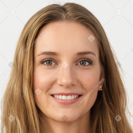 Joyful white young-adult female with long  brown hair and green eyes