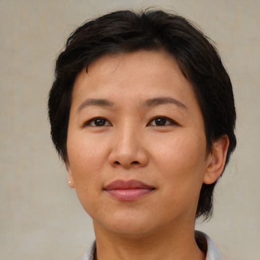 Joyful asian adult female with medium  brown hair and brown eyes