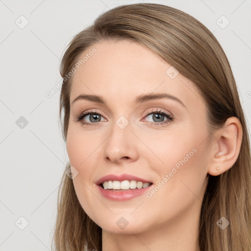 Joyful white young-adult female with long  brown hair and grey eyes