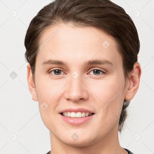 Joyful white young-adult female with short  brown hair and grey eyes