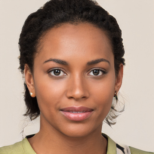 Joyful black young-adult female with medium  brown hair and brown eyes