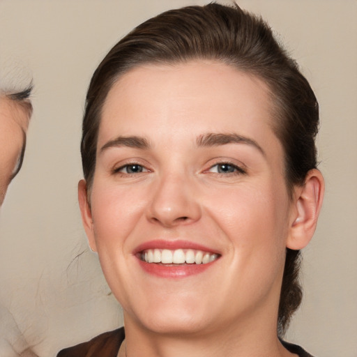 Joyful white young-adult female with medium  brown hair and brown eyes