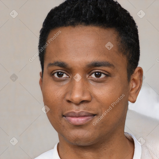 Joyful black young-adult male with short  black hair and brown eyes