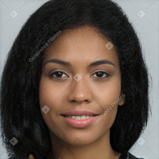 Joyful black young-adult female with long  brown hair and brown eyes