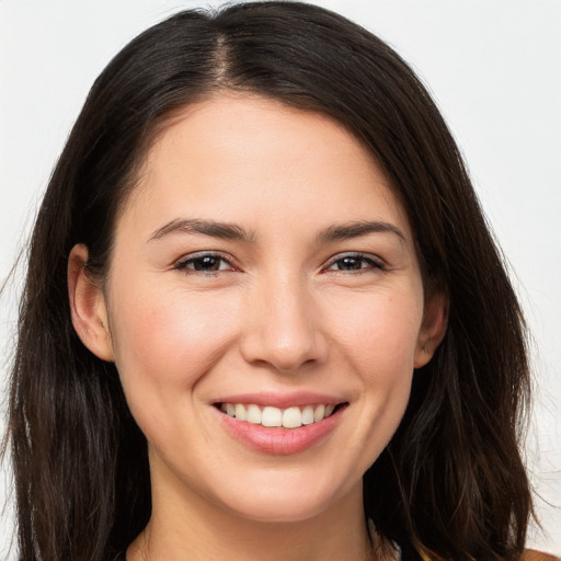 Joyful white young-adult female with long  brown hair and brown eyes