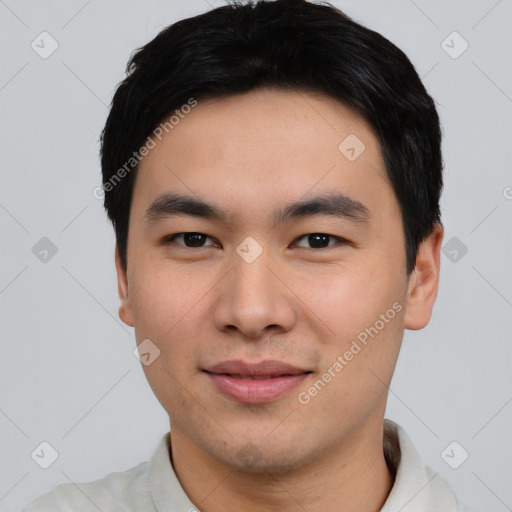 Joyful asian young-adult male with short  black hair and brown eyes