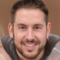 Joyful white adult male with short  brown hair and brown eyes