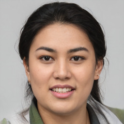 Joyful asian young-adult female with medium  brown hair and brown eyes