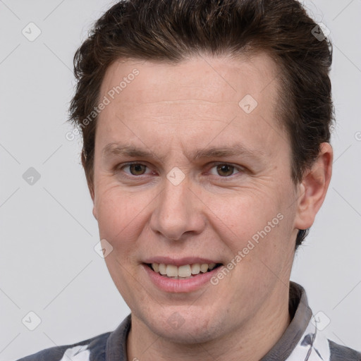 Joyful white adult male with short  brown hair and brown eyes