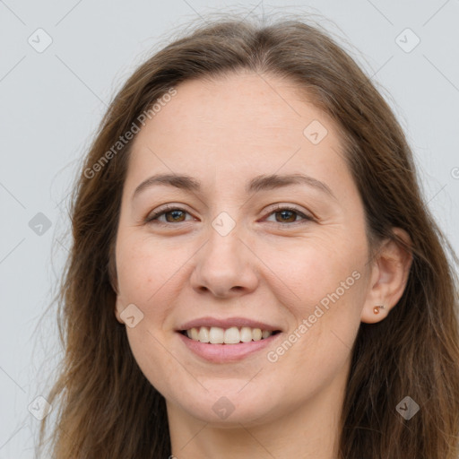 Joyful white adult female with long  brown hair and brown eyes