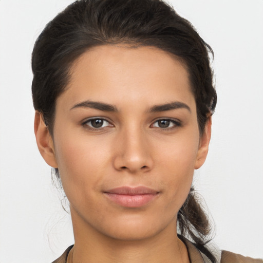 Joyful latino young-adult female with medium  brown hair and brown eyes