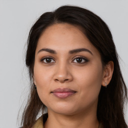 Joyful latino young-adult female with long  brown hair and brown eyes