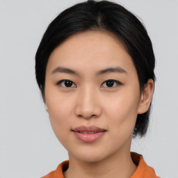 Joyful asian young-adult female with medium  black hair and brown eyes