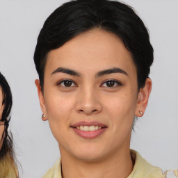 Joyful latino young-adult female with short  brown hair and brown eyes