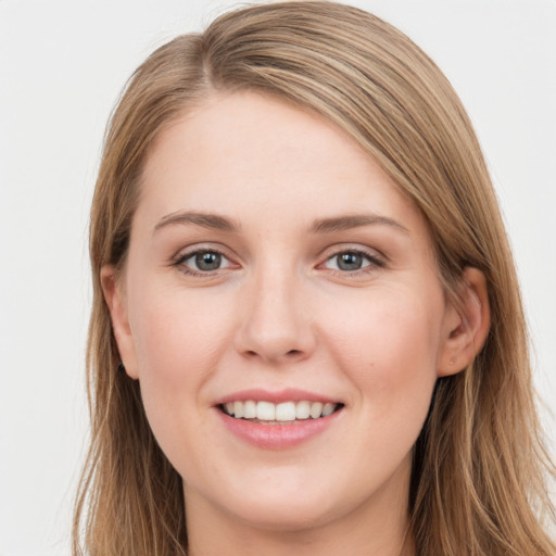 Joyful white young-adult female with long  brown hair and grey eyes