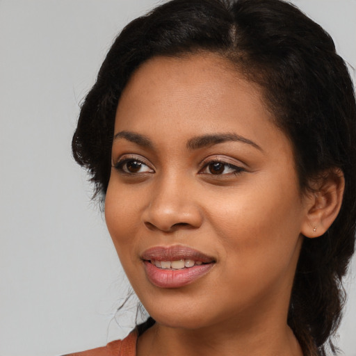 Joyful latino young-adult female with medium  black hair and brown eyes