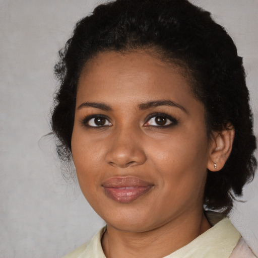 Joyful black young-adult female with medium  black hair and brown eyes