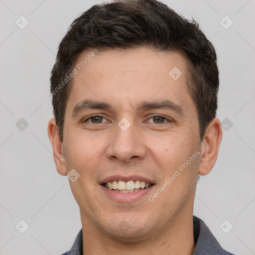 Joyful white young-adult male with short  brown hair and brown eyes