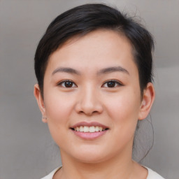 Joyful asian young-adult female with medium  brown hair and brown eyes