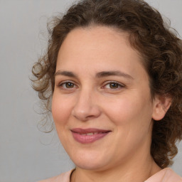 Joyful white adult female with medium  brown hair and brown eyes