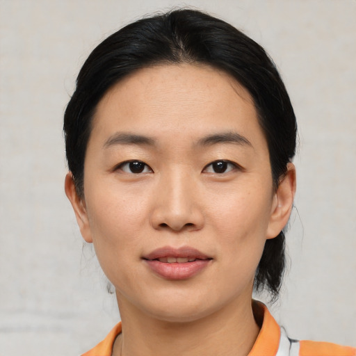Joyful asian young-adult female with medium  black hair and brown eyes