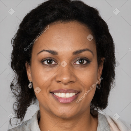 Joyful black young-adult female with long  brown hair and brown eyes