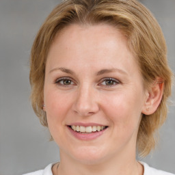 Joyful white young-adult female with medium  brown hair and blue eyes