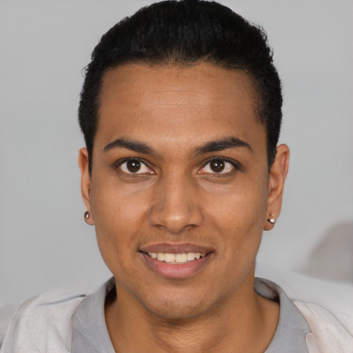 Joyful black young-adult male with short  black hair and brown eyes