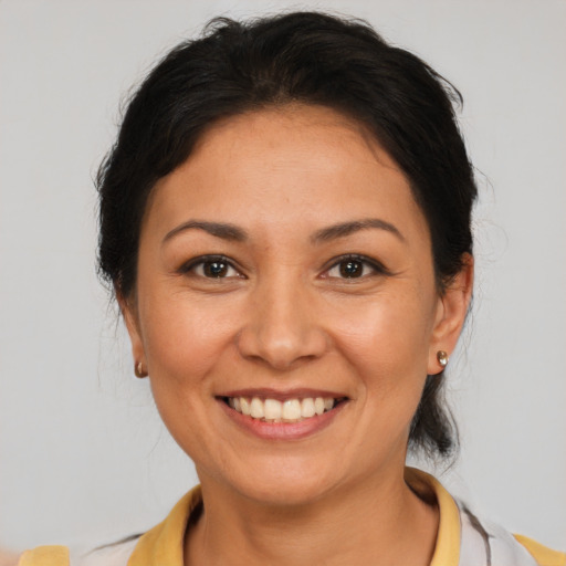 Joyful latino young-adult female with medium  brown hair and brown eyes