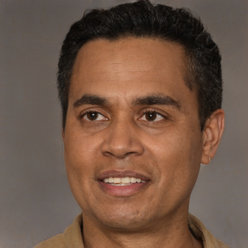 Joyful latino adult male with short  black hair and brown eyes
