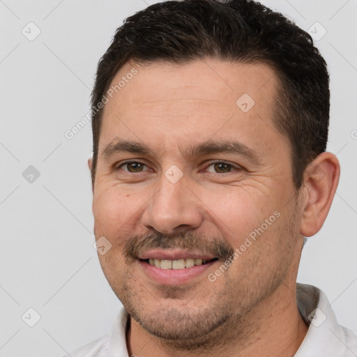 Joyful white adult male with short  brown hair and brown eyes