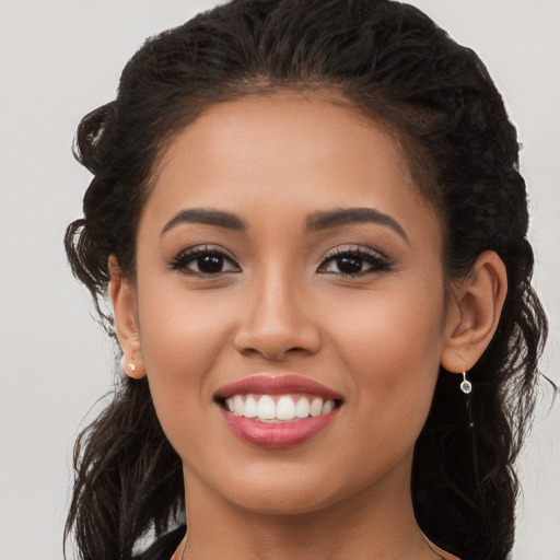 Joyful latino young-adult female with long  brown hair and brown eyes